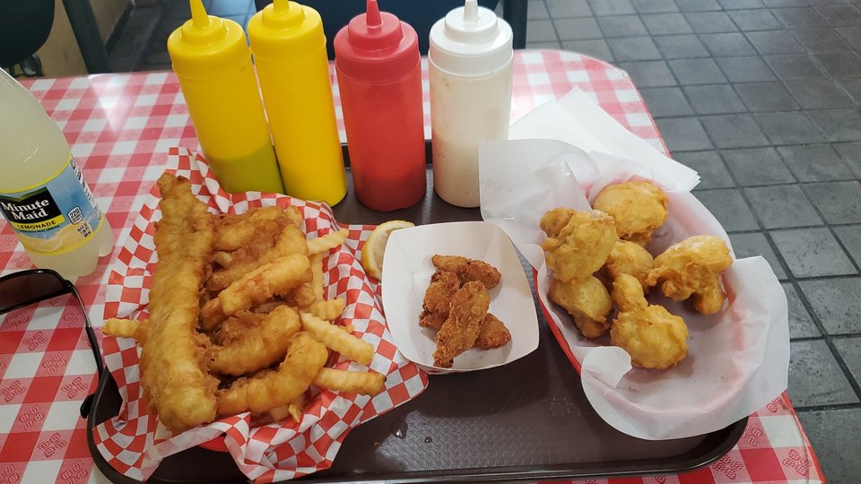 Crispy seafood plates beside tartar sauce.